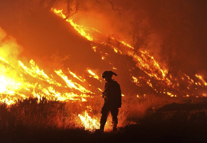 FILE - In this Aug. 3, 2015, file photo CalFire firefighter Bo Santiago lights a backfire as the Rocky fire burns near Clearlake, Calif. A new study says dying wildlife, bigger wildfires and drying-up farm towns will be the biggest crises if Californiaís four-year drought continues. A report released overnight Wednesday to Thursday, Aug. 20, by the Public Policy Institute of California non-profit think-tank sketches that picture of California in 2016, and 2017, if the stateís driest four years on record stretches into a fifth, or sixth, year of drought. (AP Photo/Josh Edelson, File)